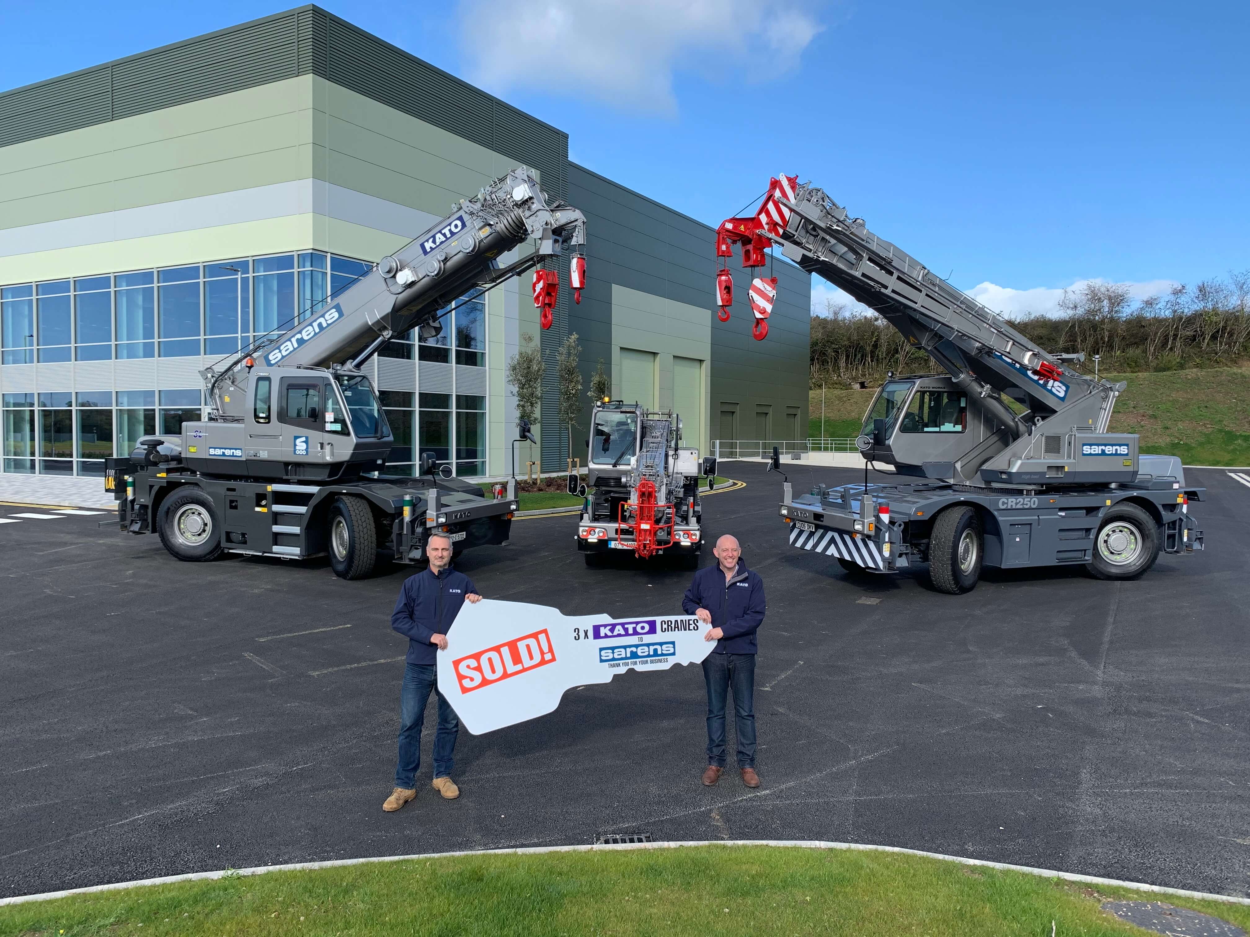 Ivan Bolster (L) and Colin Cleary of Kato hand over the new cranes virtually at its facility in Cork, Ireland 